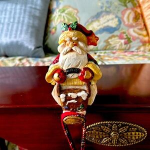 Santa stocking holder with mistletoe on hat.